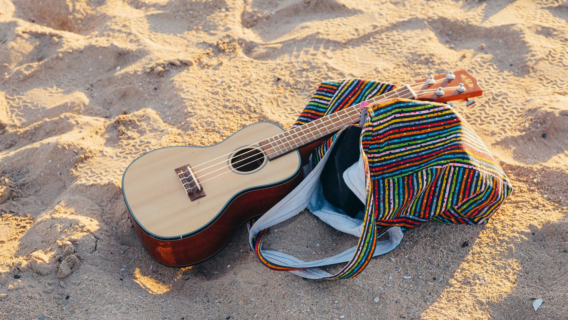 beach bag and guitar on beach sand
learn guitar
guitar tricks review

