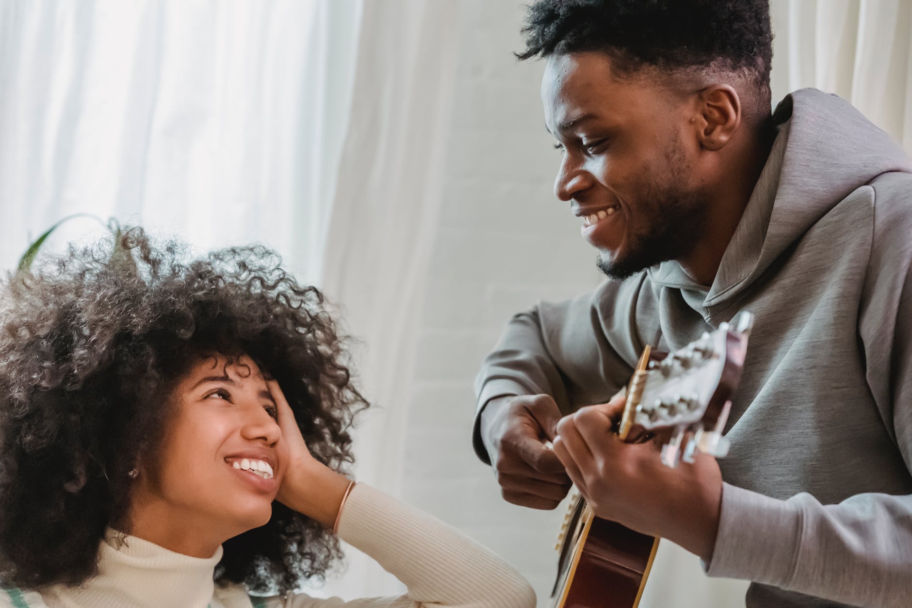 cheerful black couple with guitar